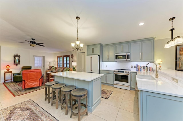 133 Tucker Ave, Sarasota, FL 34232 - kitchen featuring high quality stove, stainless steel microwave, freestanding refrigerator, light countertops, and recessed lighting