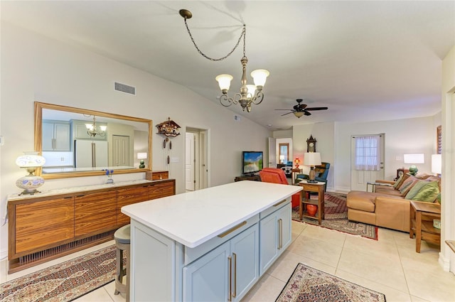 133 Tucker Ave, Sarasota, FL 34232 - kitchen featuring a chandelier, open floor plan, vaulted ceiling, light countertops, and a ceiling fan