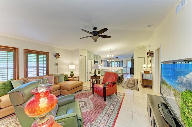 133 Tucker Ave, Sarasota, FL 34232 - living area featuring a ceiling fan, light tile patterned floors, healthy amount of natural light, and a chandelier