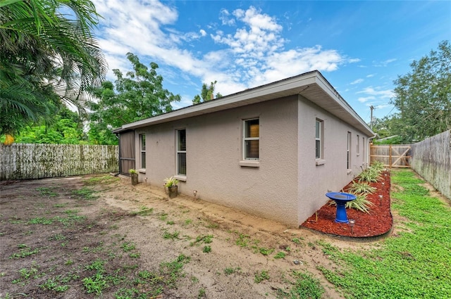 133 Tucker Ave, Sarasota, FL 34232 - view of property exterior featuring stucco siding and a fenced backyard
