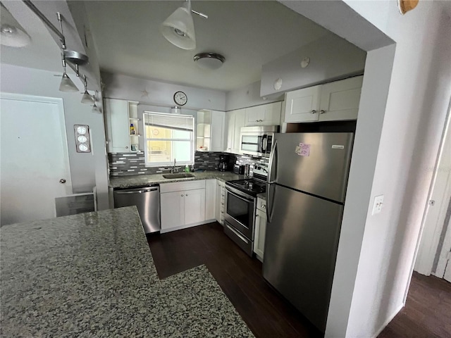 611 Gulf Dr N Unit B24, Bradenton Beach, FL 34217 - kitchen with stainless steel appliances, dark wood-style floors, dark stone counters, and backsplash