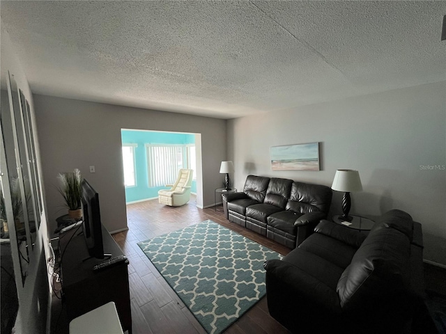 611 Gulf Dr N Unit B24, Bradenton Beach, FL 34217 - living room with a textured ceiling and dark wood-style flooring