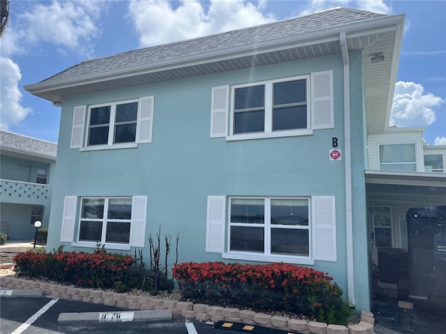 611 Gulf Dr N Unit B24, Bradenton Beach, FL 34217 - view of home's exterior with uncovered parking and stucco siding