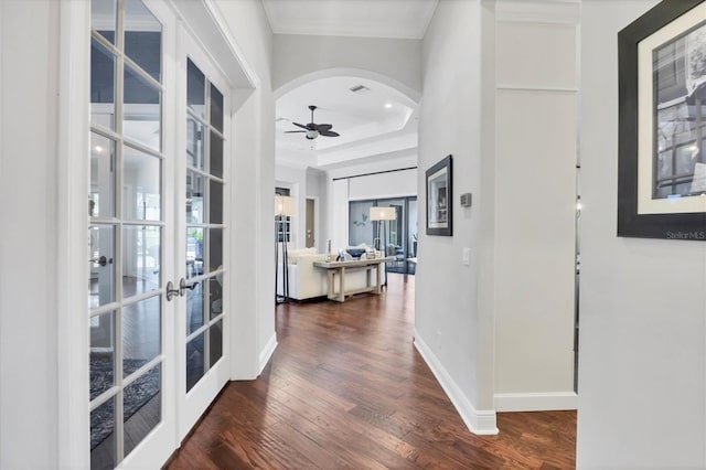 14611 Leopard Creek Pl, Lakewood Ranch, FL 34202 - corridor featuring french doors, dark wood-style flooring, crown molding, arched walkways, and a raised ceiling
