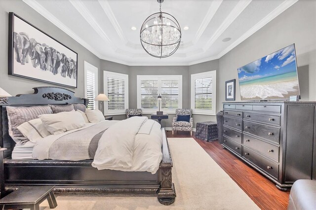 14611 Leopard Creek Pl, Lakewood Ranch, FL 34202 - bedroom featuring a chandelier, dark wood finished floors, a raised ceiling, ornamental molding, and recessed lighting