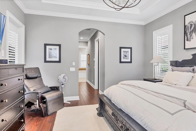 14611 Leopard Creek Pl, Lakewood Ranch, FL 34202 - bedroom with arched walkways, hardwood / wood-style floors, a tray ceiling, and ornamental molding