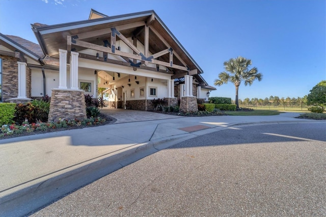 14611 Leopard Creek Pl, Lakewood Ranch, FL 34202 - view of front facade featuring stone siding, stucco siding, a balcony, and driveway