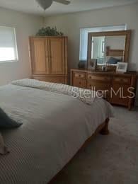 1002 Oakleaf Blvd, Bradenton, FL 34208 - bedroom featuring ceiling fan and carpet floors