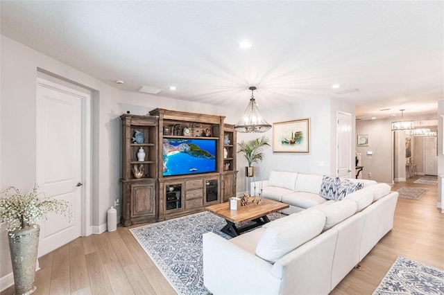 4316 Rustling Pines Ter, Parrish, FL 34219 - living room with a chandelier, light wood finished floors, and recessed lighting