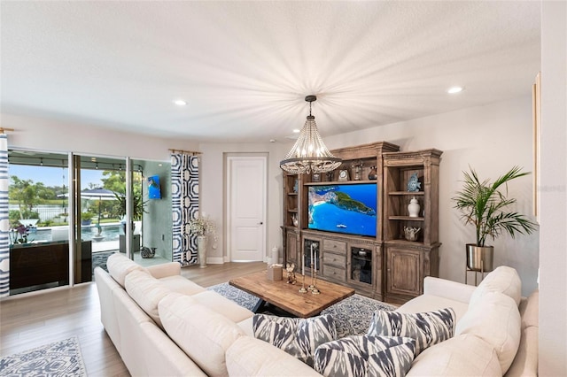 4316 Rustling Pines Ter, Parrish, FL 34219 - living room featuring a chandelier, recessed lighting, and light wood-style floors
