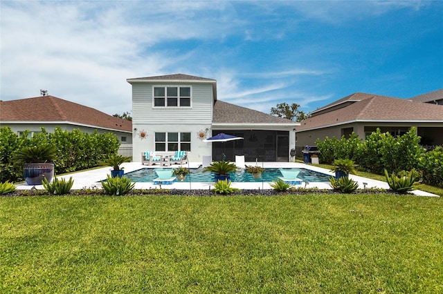 4316 Rustling Pines Ter, Parrish, FL 34219 - rear view of house featuring a sunroom, a yard, roof with shingles, and a patio area