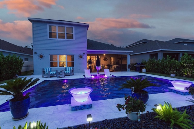 4316 Rustling Pines Ter, Parrish, FL 34219 - rear view of property featuring an outdoor hangout area, a patio area, and an outdoor pool