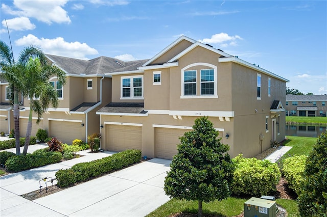 11558 84th Street Cir E Unit 106, Parrish, FL 34219 - traditional home with stucco siding, a garage, and driveway
