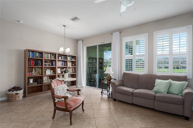 11558 84th Street Cir E Unit 106, Parrish, FL 34219 - living room with a chandelier, light tile patterned floors, and a ceiling fan