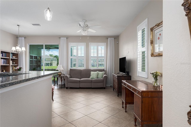 11558 84th Street Cir E Unit 106, Parrish, FL 34219 - living room featuring ceiling fan, light tile patterned floors, and a chandelier