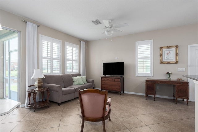 11558 84th Street Cir E Unit 106, Parrish, FL 34219 - living room with a ceiling fan, healthy amount of natural light, and light tile patterned floors
