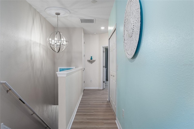 11558 84th Street Cir E Unit 106, Parrish, FL 34219 - hall with an upstairs landing, wood finished floors, and a chandelier