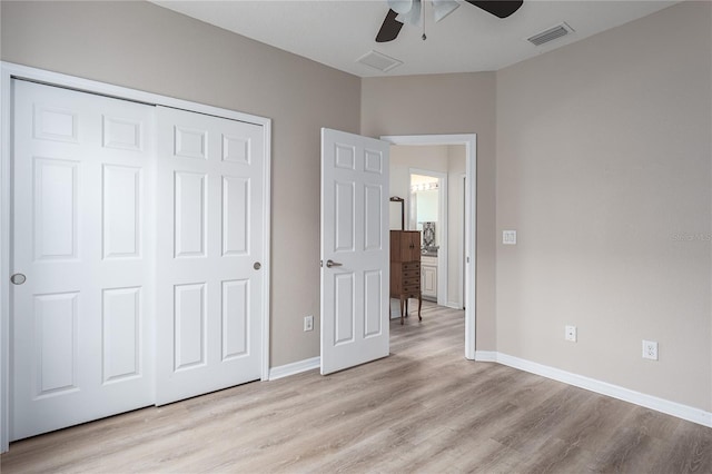 11558 84th Street Cir E Unit 106, Parrish, FL 34219 - unfurnished bedroom with light wood-type flooring, a closet, and ceiling fan