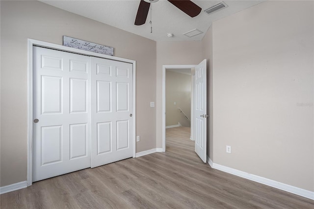 11558 84th Street Cir E Unit 106, Parrish, FL 34219 - unfurnished bedroom with wood finished floors, a closet, and ceiling fan