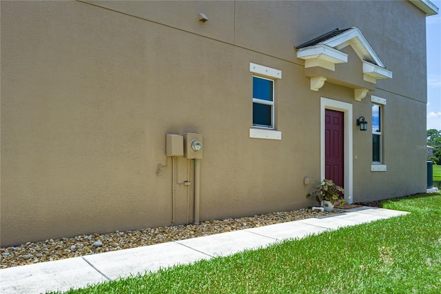 11558 84th Street Cir E Unit 106, Parrish, FL 34219 - property entrance with stucco siding and a lawn