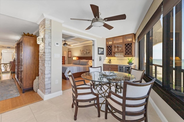 840 The Esplanade N Unit 805, Venice, FL 34285 - dining room featuring a ceiling fan, decorative columns, ornamental molding, beverage cooler, and light wood-style flooring