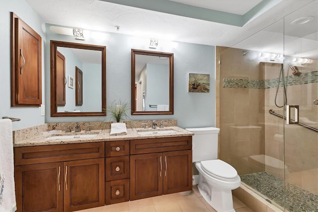840 The Esplanade N Unit 805, Venice, FL 34285 - bathroom featuring a shower stall, double vanity, and tile patterned flooring