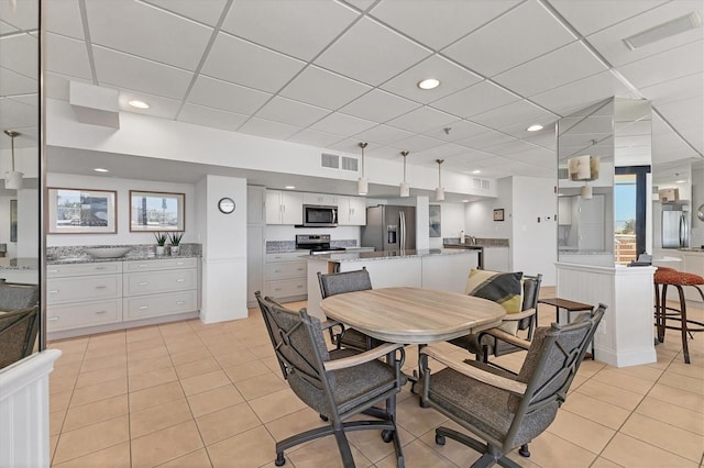 840 The Esplanade N Unit 805, Venice, FL 34285 - dining room with light tile patterned floors and a paneled ceiling