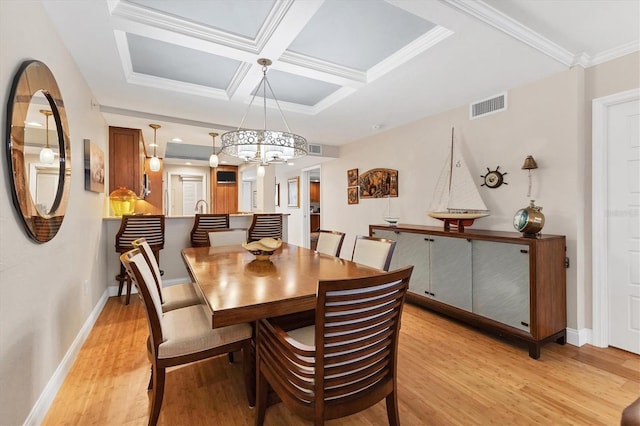 840 The Esplanade N Unit 805, Venice, FL 34285 - dining space with light wood-type flooring, a chandelier, coffered ceiling, and crown molding