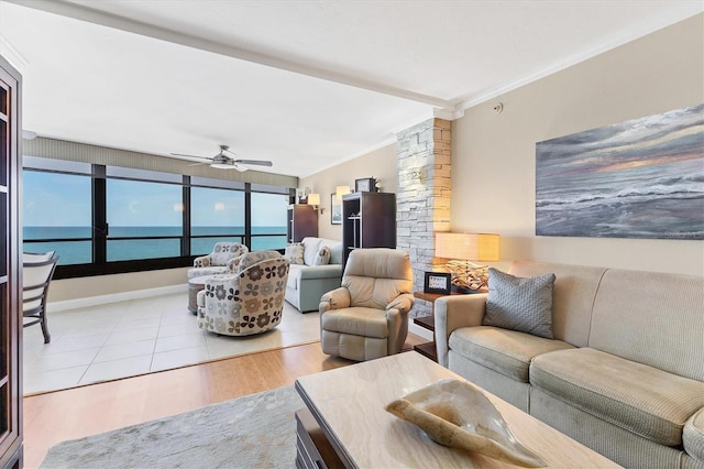 840 The Esplanade N Unit 805, Venice, FL 34285 - living room featuring crown molding, ceiling fan, decorative columns, and a water view