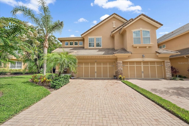 5427 Napa Dr, Sarasota, FL 34243 - multi unit property with stucco siding, driveway, an attached garage, and stone siding