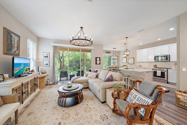 5427 Napa Dr, Sarasota, FL 34243 - living room with a chandelier, recessed lighting, and light wood-style floors