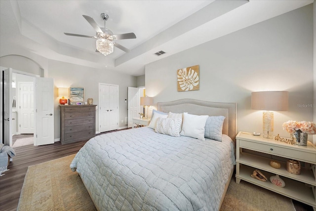 5427 Napa Dr, Sarasota, FL 34243 - bedroom with a tray ceiling, wood finished floors, and ceiling fan