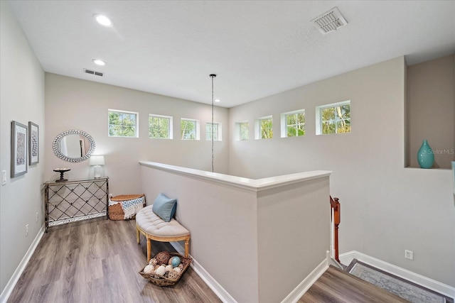 5427 Napa Dr, Sarasota, FL 34243 - hallway with an upstairs landing, plenty of natural light, wood finished floors, and recessed lighting