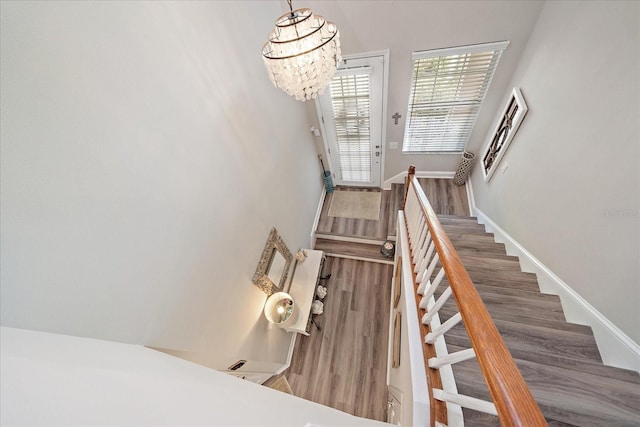 5427 Napa Dr, Sarasota, FL 34243 - stairs with wood finished floors and a chandelier