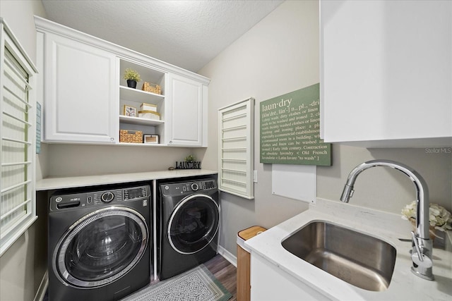 5427 Napa Dr, Sarasota, FL 34243 - laundry area with cabinet space, washer and dryer, a textured ceiling, and wood finished floors