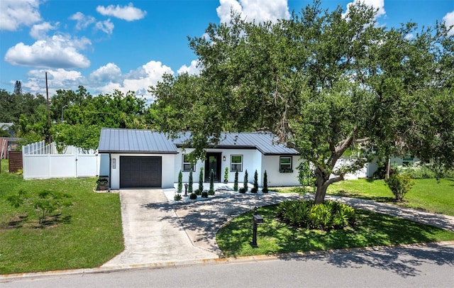 3439 Fair Oaks Pl, Sarasota, FL 34239 - view of front of home featuring driveway, an attached garage, a metal roof, and stucco siding