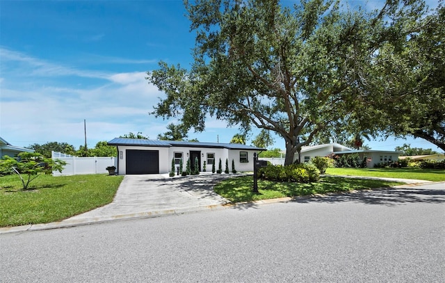 3439 Fair Oaks Pl, Sarasota, FL 34239 - mid-century inspired home with an attached garage, asphalt driveway, stucco siding, and a metal roof