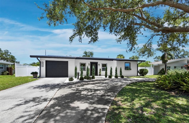 3439 Fair Oaks Pl, Sarasota, FL 34239 - mid-century home with a garage, concrete driveway, and stucco siding