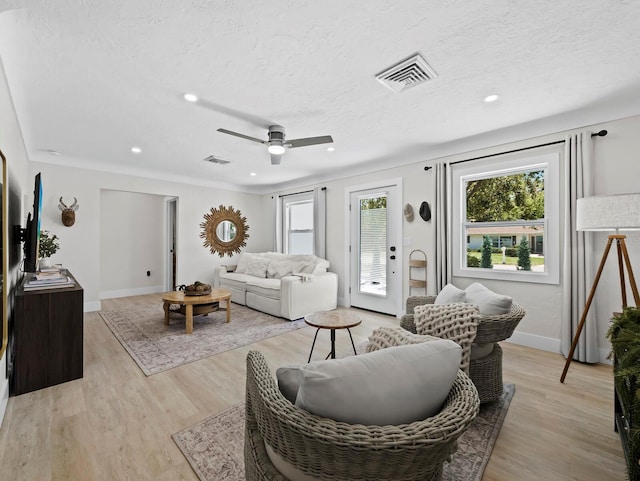 3439 Fair Oaks Pl, Sarasota, FL 34239 - living room featuring healthy amount of natural light, a ceiling fan, recessed lighting, light wood-style flooring, and a textured ceiling