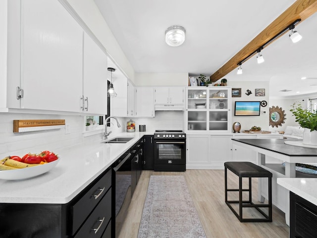 3439 Fair Oaks Pl, Sarasota, FL 34239 - kitchen with black appliances, dark cabinetry, white cabinetry, light wood-type flooring, and light countertops