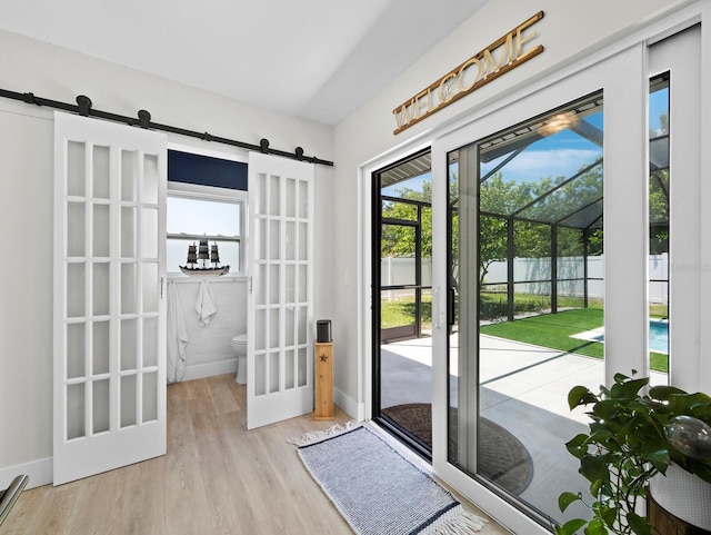 3439 Fair Oaks Pl, Sarasota, FL 34239 - doorway with a barn door and wood finished floors