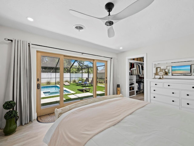 3439 Fair Oaks Pl, Sarasota, FL 34239 - bedroom featuring access to exterior, light wood finished floors, a spacious closet, ceiling fan, and recessed lighting
