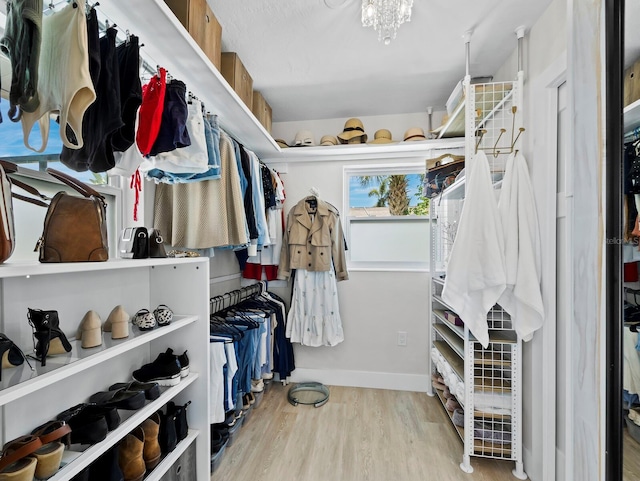3439 Fair Oaks Pl, Sarasota, FL 34239 - spacious closet featuring wood finished floors and a chandelier