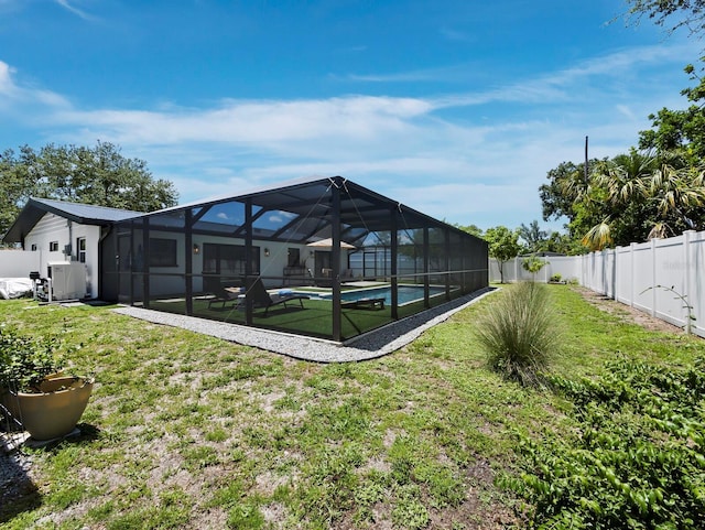 3439 Fair Oaks Pl, Sarasota, FL 34239 - rear view of property with a fenced backyard, a patio area, and a lanai