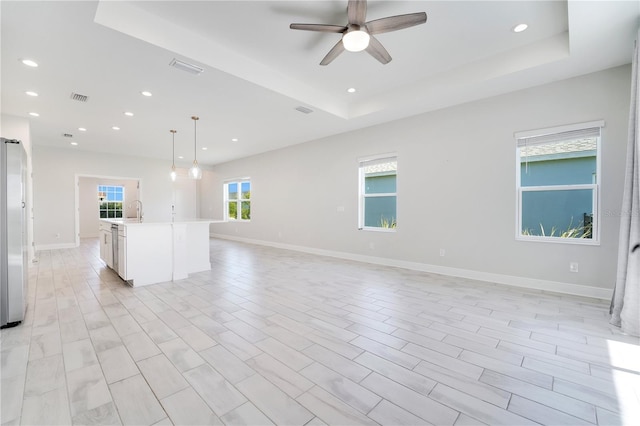 13832 Old Creek Ct, Parrish, FL 34219 - unfurnished living room with a raised ceiling, ceiling fan, and recessed lighting