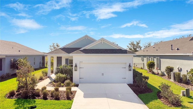 13832 Old Creek Ct, Parrish, FL 34219 - ranch-style home with concrete driveway, an attached garage, a shingled roof, stucco siding, and a front lawn