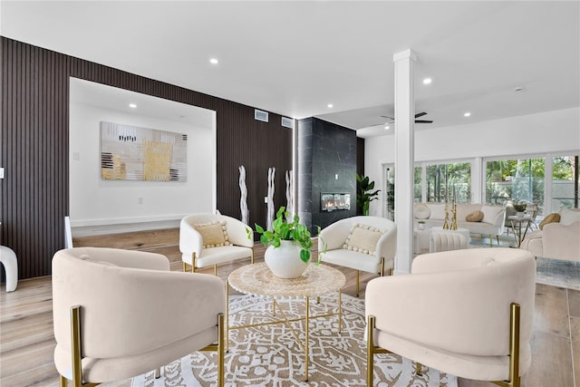 4879 Commonwealth Dr, Sarasota, FL 34242 - living area featuring light wood-style flooring, a fireplace, recessed lighting, and ceiling fan