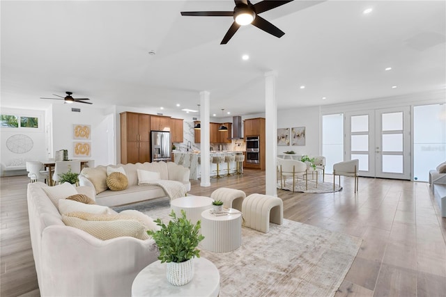 4879 Commonwealth Dr, Sarasota, FL 34242 - living room with ceiling fan, decorative columns, recessed lighting, and light wood finished floors