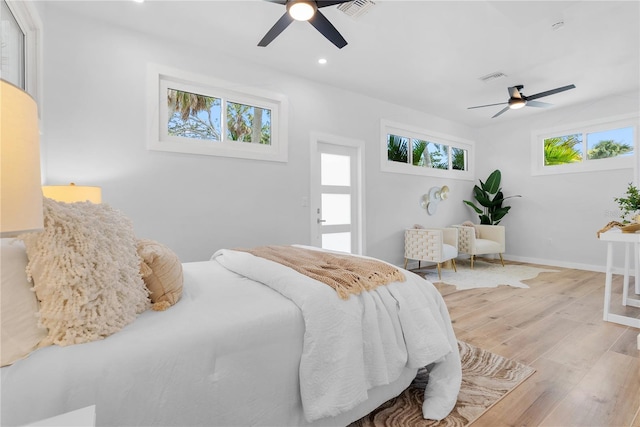 4879 Commonwealth Dr, Sarasota, FL 34242 - bedroom featuring multiple windows, wood finished floors, recessed lighting, and ceiling fan