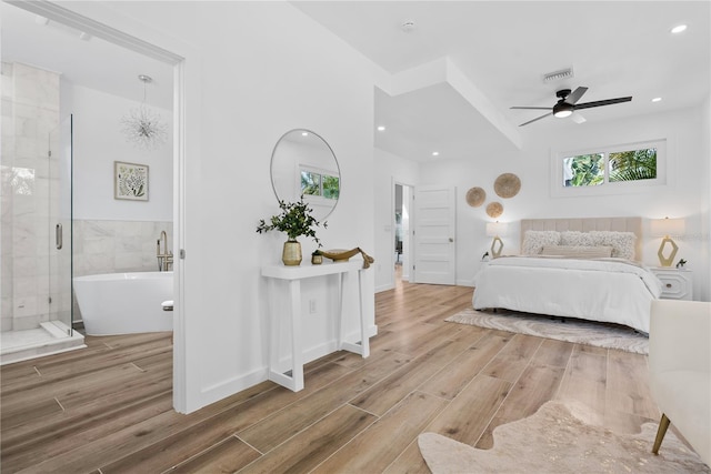 4879 Commonwealth Dr, Sarasota, FL 34242 - bedroom with wood finished floors, recessed lighting, and ensuite bathroom